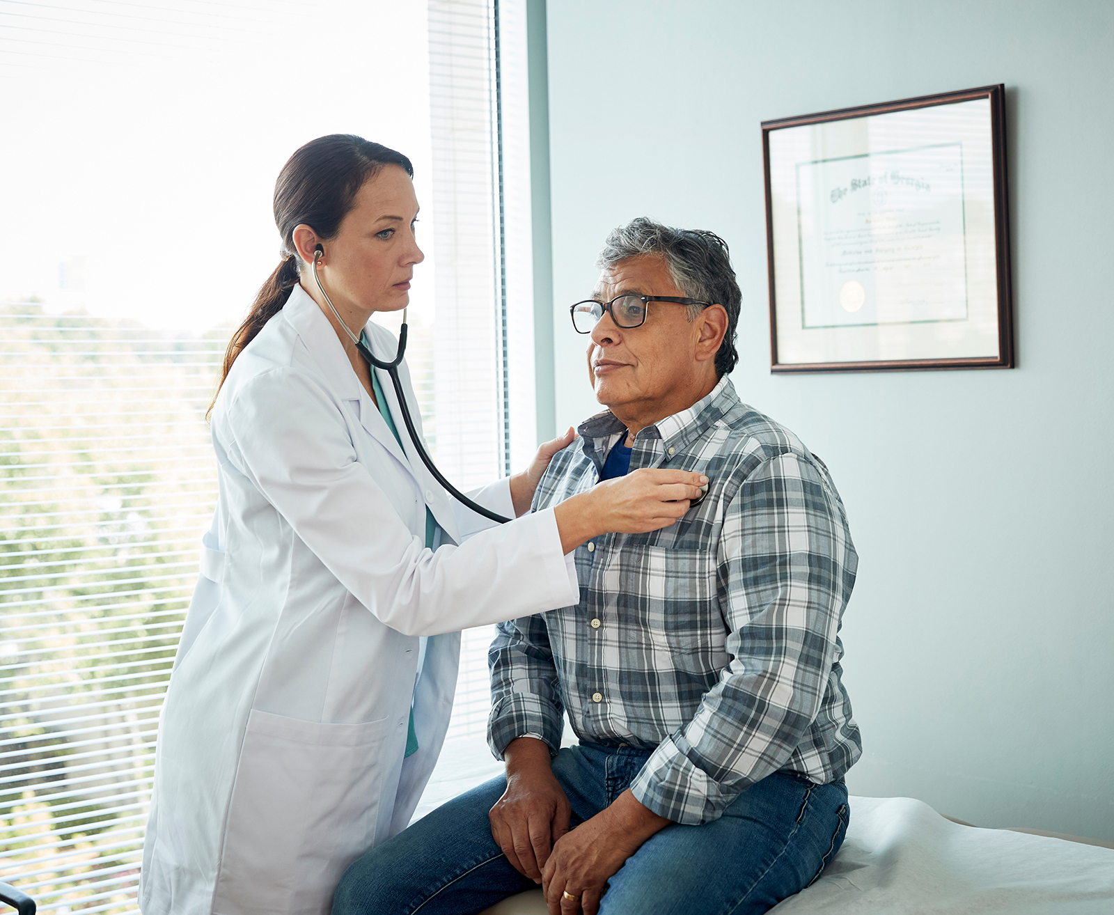 Doctor giving exam to man
