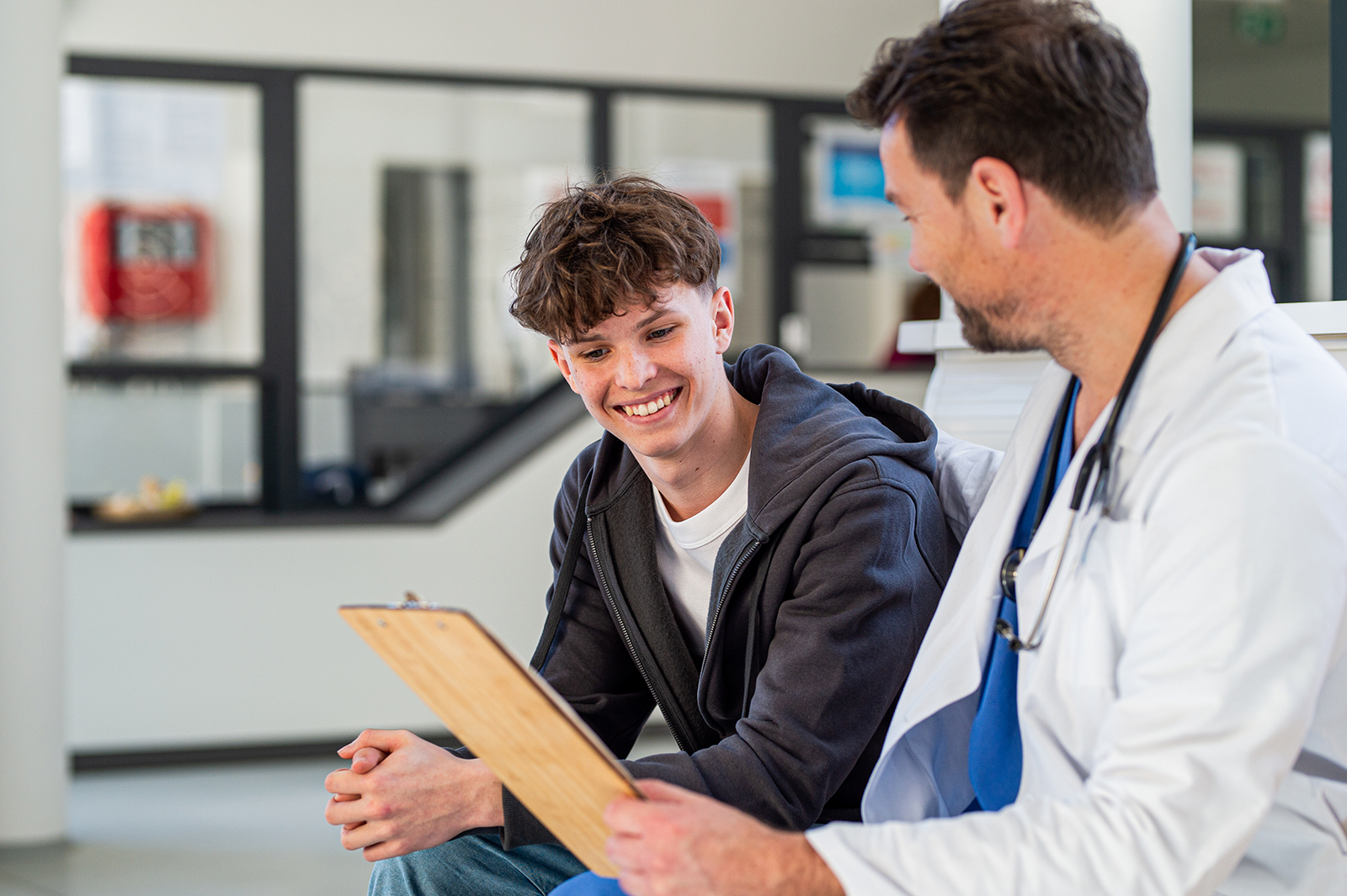 Teen and doctor during sports physical