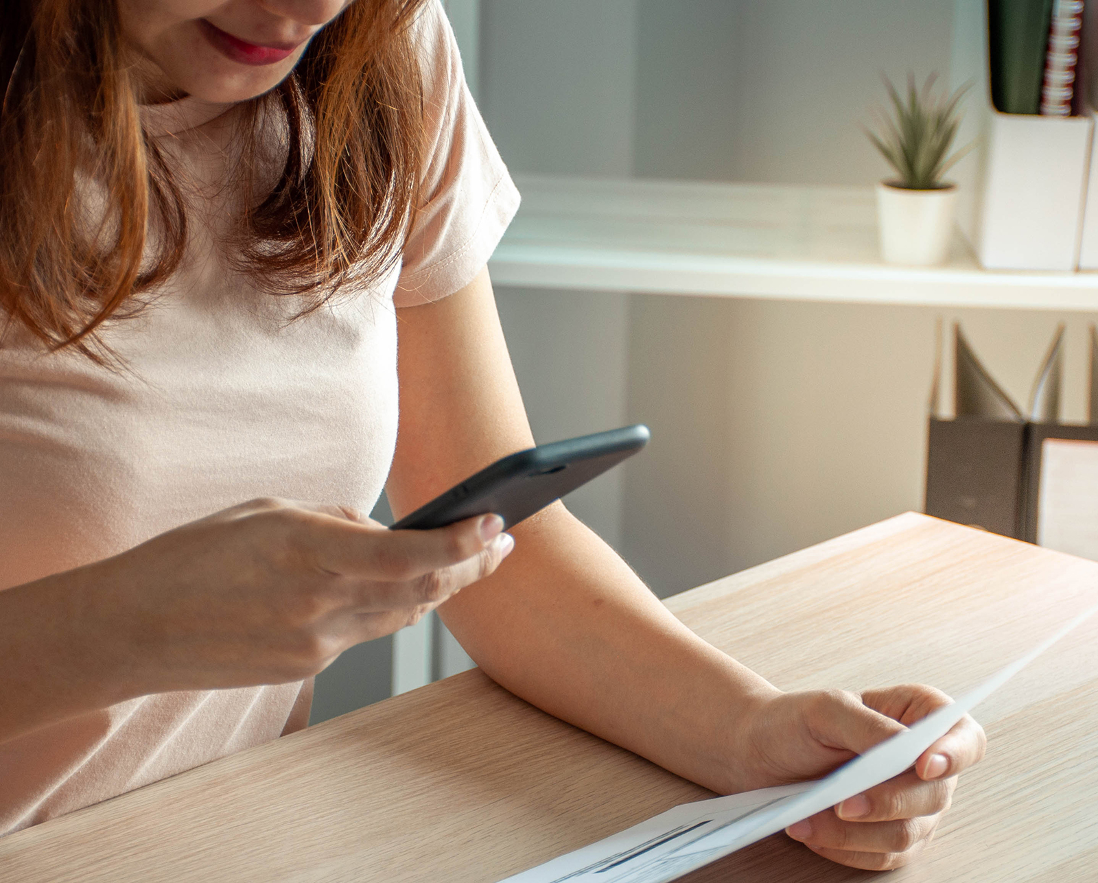 Woman using a smartphone to pay a bill